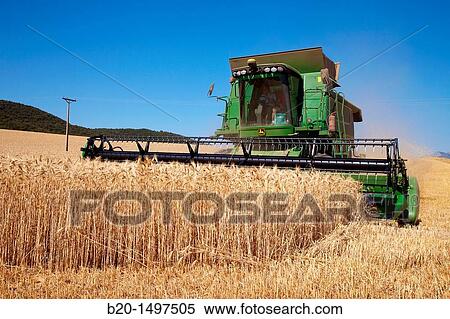 Agricultural machinery Combine harvester on field of wheat? Learza? estate Near Estella, Navarre, Spain View Large Photo Image Stock Photography - Agricultural machinery Combine harvester on field of wheat? Learza? estate Near Estella, Navarre, Spain. Fotosearch