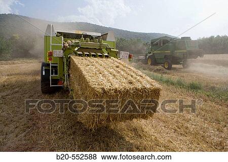 Agricultural machinery. Pick-up baler. Harvesting of cereals,? Learza? estate. Near Estella, Navarre, Spain View Large Photo Image Stock Photo - Agricultural machinery. Pick-up baler. Harvesting of cereals,? Learza? estate. Near Estella, Navarre, Spain. Fotosearch