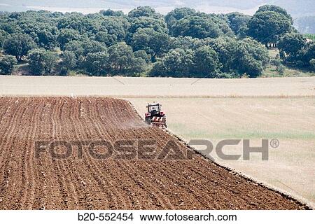 Agricultural machinery. Tractor ploughing the land. Mouldboard plough. Harvesting of cereals, Oco (near Estella), Navarre, Spain View Large Photo Image Picture - Agricultural machinery. Tractor ploughing the land. Mouldboard plough. Harvesting of cereals, Oco (near Estella), Navarre, Spain. Fotosearch