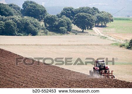 Agricultural machinery. Tractor ploughing the land. Mouldboard plough. Harvesting of cereals, Oco-Navarra (near Estella), Navarre, Spain View Large Photo Image Stock Image - Agricultural machinery. Tractor ploughing the land. Mouldboard plough. Harvesting of cereals, Oco-Navarra (near Estella), Navarre, Spain. Fotosearch