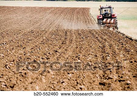Agricultural machinery. Tractor ploughing the land. Mouldboard plough. Harvesting of cereals, Oco (near Estella), Navarre, Spain View Large Photo Image Stock Image - Agricultural machinery. Tractor ploughing the land. Mouldboard plough. Harvesting of cereals, Oco (near Estella), Navarre, Spain. Fotosearch