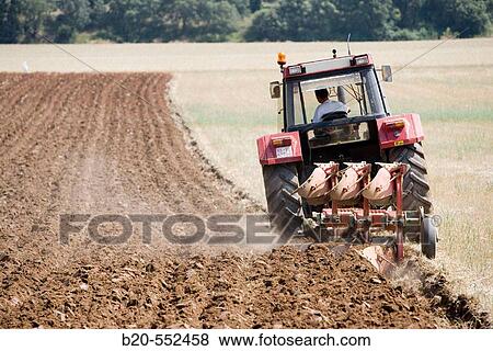 Agricultural machinery. Tractor ploughing the land. Mouldboard plough. Harvesting of cereals, Oco (near Estella), Navarre, Spain View Large Photo Image Stock Photo - Agricultural machinery. Tractor ploughing the land. Mouldboard plough. Harvesting of cereals, Oco (near Estella), Navarre, Spain. Fotosearch