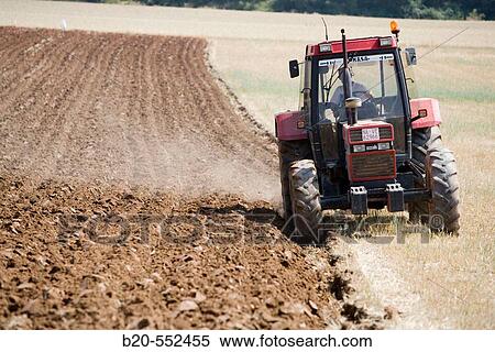 Agricultural machinery. Tractor ploughing the land. Mouldboard plough. Harvesting of cereals, Oco (near Estella), Navarre, Spain View Large Photo Image Stock Photography - Agricultural machinery. Tractor ploughing the land. Mouldboard plough. Harvesting of cereals, Oco (near Estella), Navarre, Spain. Fotosearch