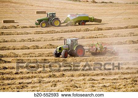Agricultural machinery. Windrower and Pick-up baler. Harvesting of cereals,? Learza? estate. Near Estella, Navarre, Spain View Large Photo Image Stock Image - Agricultural machinery. Windrower and Pick-up baler. Harvesting of cereals,? Learza? estate. Near Estella, Navarre, Spain. Fotosearch