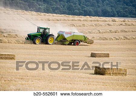 Agricultural machinery. Windrower and Pick-up baler. Harvesting of cereals,? Learza? estate. Near Estella, Navarre, Spain View Large Photo Image Stock Image - Agricultural machinery. Windrower and Pick-up baler. Harvesting of cereals,? Learza? estate. Near Estella, Navarre, Spain. Fotosearch