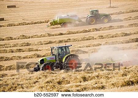 Agricultural machinery. Windrower and Pick-up baler. Harvesting of cereals,? Learza? estate. Near Estella, Navarre, Spain View Large Photo Image Stock Photo - Agricultural machinery. Windrower and Pick-up baler. Harvesting of cereals,? Learza? estate. Near Estella, Navarre, Spain. Fotosearch