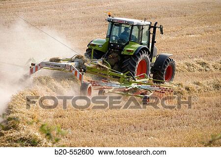 Agricultural machinery. Windrower. Harvesting of cereals,? Learza? estate. Near Estella, Navarre, Spain View Large Photo Image Stock Image - Agricultural machinery. Windrower. Harvesting of cereals,? Learza? estate. Near Estella, Navarre, Spain. Fotosearch