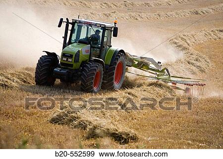 Stock Photo - Agricultural machinery. Windrower. Harvesting of cereals,? Learza? estate. Near Estella, Navarre, Spain. Fotosearch