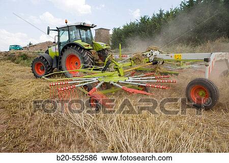 Agricultural machinery. Windrower. Harvesting of cereals,? Learza? estate. Near Estella, Navarre, Spain View Large Photo Image Stock Photograph - Agricultural machinery. Windrower. Harvesting of cereals,? Learza? estate. Near Estella, Navarre, Spain. Fotosearch