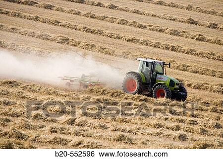 Agricultural machinery. Windrower. Harvesting of cereals,? Learza? estate. Near Estella, Navarre, Spain View Large Photo Image Stock Photograph - Agricultural machinery. Windrower. Harvesting of cereals,? Learza? estate. Near Estella, Navarre, Spain. Fotosearch