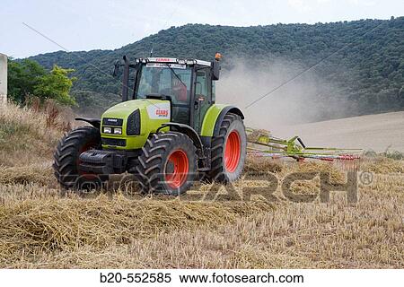 Agricultural machinery. Windrower. Harvesting of cereals,? Learza? estate. Near Estella, Navarre, Spain View Large Photo Image Stock Photography - Agricultural machinery. Windrower. Harvesting of cereals,? Learza? estate. Near Estella, Navarre, Spain. Fotosearch