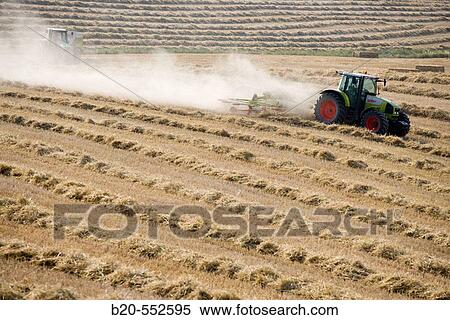 Agricultural machinery. Windrower. Harvesting of cereals,? Learza? estate. Near Estella, Navarre, Spain View Large Photo Image Stock Photography - Agricultural machinery. Windrower. Harvesting of cereals,? Learza? estate. Near Estella, Navarre, Spain. Fotosearch