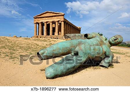 Agrigento Sicily Italy Temple of Concordia & Fallen Ikarus sculpture by Igor Mitoraj, Valley of the Temples archaeological site View Large Photo Image Stock Photo - Agrigento Sicily Italy Temple of Concordia & Fallen Ikarus sculpture by Igor Mitoraj, Valley of the Temples archaeological site. Fotosearch
