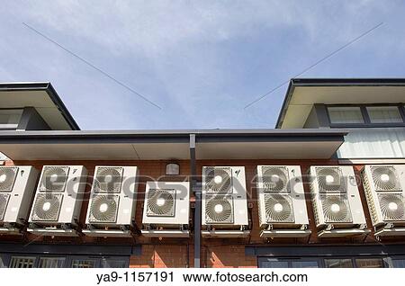 Air conditioner units on exterior wall of building View Large Photo Image Stock Image - Air conditioner units on exterior wall of building. Fotosearch