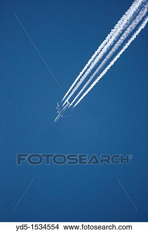 Aircraft leaving a vapour trail View Large Photo Image Picture - Aircraft leaving a vapour trail. Fotosearch