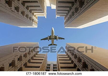 Airplane flying over a Building, Pune, Maharashtra, India View Large Photo Image Stock Photo - Airplane flying over a Building, Pune, Maharashtra, India. Fotosearch