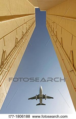 Stock Photo - Airplane flying over a Building, Pune, Maharashtra, India. Fotosearch