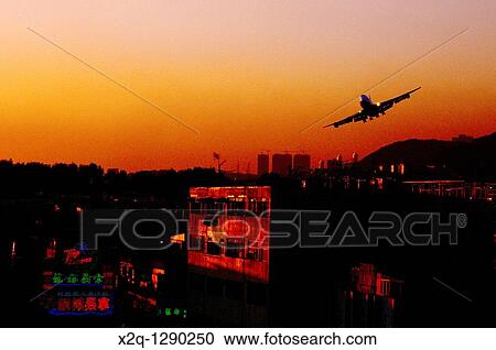 Airplane landing at the old Kai Tak Airport in Hong Kong View Large Photo Image Stock Image - Airplane landing at the old Kai Tak Airport in Hong Kong. Fotosearch