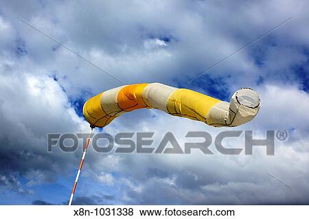 Airport windsock blowing in the breeze with a sky background View Large Photo Image Stock Photo - Airport windsock blowing in the breeze with a sky background. Fotosearch