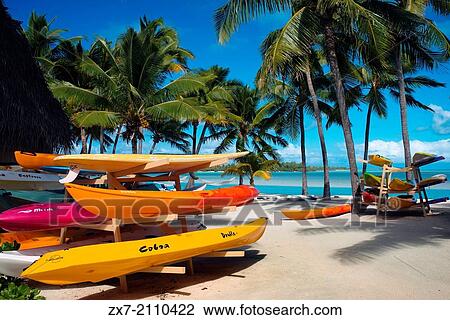 Stock Image - Aitutaki. Cook Island. Polynesia. South Pacific Ocean. Some kayaks await tourists on the beach in Aitutaki Lagoon Resort & Spa Hotel.. Fotosearch