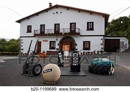 Stock Photo - Aizkolari (wood-chopping) and Harrijasotzaile (stone lifting), Basque rural sports, Aduna, Gipuzkoa, Basque Country, Spain. Fotosearch