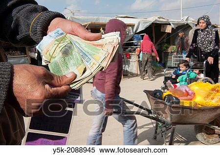 Al Za? atari, Al Mafraq region, Jordan, Middle-East. The UNHCR refugee camp, near the border with Syria. Economic activities started soon after the camp was founded, including money changers in the camp's main street. View Large Photo Image Stock Photography - Al Za? atari, Al Mafraq region, Jordan, Middle-East. The UNHCR refugee camp, near the border with Syria. Economic activities started soon after the camp was founded, including money changers in the camp's main street.. Fotosearch