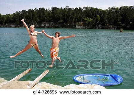 Stock Photography - Alabama, St Stephens, St Stephens Historic Site, former quarry, girl, boy, teen, dive, jump, swim, refresh, fun, recreation, summer, bikini,. Fotosearch