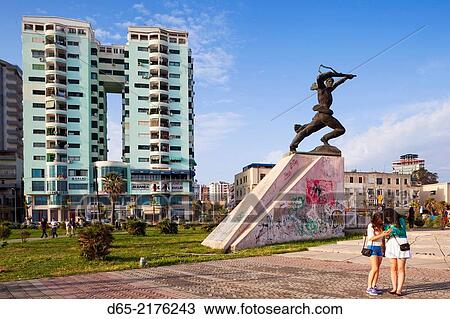 Stock Image - Albania, Durres, beachfront promenade and Communist-era statue.. Fotosearch