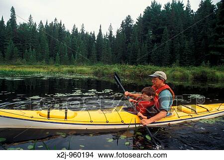 Algonquin Provincial Park, Ontario Canada - John West and his son Joe, 4, kayaking on the Tim River View Large Photo Image Picture - Algonquin Provincial Park, Ontario Canada - John West and his son Joe, 4, kayaking on the Tim River. Fotosearch