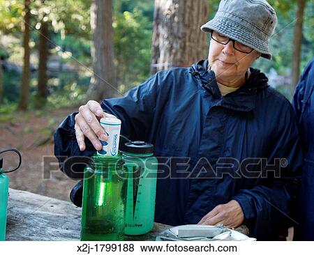 Algonquin Provincial Park, Ontario Canada - A backcountry camper purifies water with a SteriPEN, which uses ultraviolet light to kill waterborne microbes View Large Photo Image Stock Photo - Algonquin Provincial Park, Ontario Canada - A backcountry camper purifies water with a SteriPEN, which uses ultraviolet light to kill waterborne microbes. Fotosearch