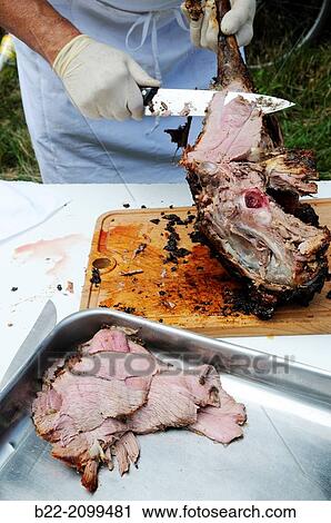 Stock Image - Aligot, the traditional dish of the Aubrac. Aligot is based on mashed potatoes, tome cheese from Laguiole and cr? me fra? che, cream, served with roast legs of lamb and sausages, Aligot? l? ancienne, La Bastide d? Aubrac, North Aveyron, Midi-Pyr? n? es, France. Fotosearch