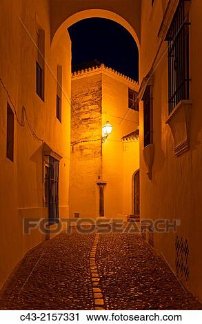 Alley at night in the hilltop White Town of Arcos de la Frontera. CBdiz province, Andalusia, Spain. View Large Photo Image Stock Image - Alley at night in the hilltop White Town of Arcos de la Frontera. CBdiz province, Andalusia, Spain.. Fotosearch