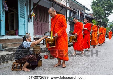 Alms giving ceremony in Luang Prabang, Laos. View Large Photo Image Stock Photo - Alms giving ceremony in Luang Prabang, Laos.. Fotosearch