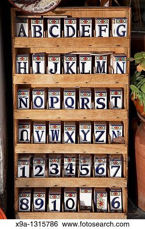 Alphabet letters and numbers on painted tiles for sale in souvenir shop in Majorca, Spain View Large Photo Image Stock Photograph - Alphabet letters and numbers on painted tiles for sale in souvenir shop in Majorca, Spain. Fotosearch
