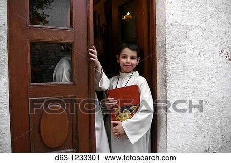 Stock Image - Altar boy, Catholic church of Antakya formerly Antioch in Hatay Province, Turkey. Fotosearch