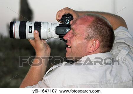 Stock Photo - Amateur photographer takes pictures of desert sunrise Debabcha Tunisia. Fotosearch