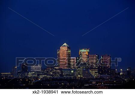 Stock Image - Amazing reddish light reflecting Canary Wharf skyline from Bermondsey, London, UK. Fotosearch