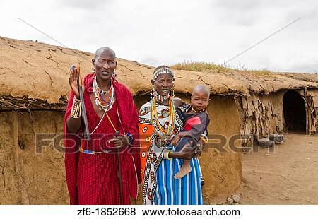 Amboseli National Park Kenya Africa safari Masai couple with child welcome to village Amboseli Maasai, hut, mud, home, beads, red, color, 1 View Large Photo Image Stock Photo - Amboseli National Park Kenya Africa safari Masai couple with child welcome to village Amboseli Maasai, hut, mud, home, beads, red, color, 1. Fotosearch