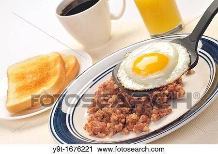 American blue plate breakfast special of a fried egg with cornbeef hash, toast, glass of orange juice and coffee closeup on white. View Large Photo Image Stock Image - American blue plate breakfast special of a fried egg with cornbeef hash, toast, glass of orange juice and coffee closeup on white.. Fotosearch