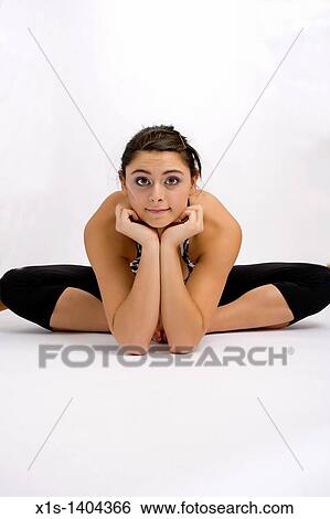 American girl in a yoga position on the floor but resting her chin on her hands and facing the camera. View Large Photo Image Stock Photograph - American girl in a yoga position on the floor but resting her chin on her hands and facing the camera.. Fotosearch