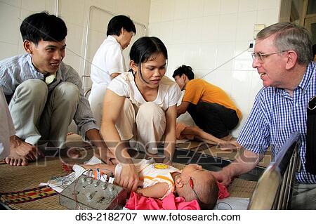 American missionary priest visiting a children's acupuncture hospital, Hanoi, Vietnam View Large Photo Image Stock Photo - American missionary priest visiting a children's acupuncture hospital, Hanoi, Vietnam. Fotosearch