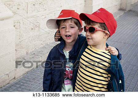 Amigos paseando por la calle View Large Photo Image Stock Photography - Amigos paseando por la calle. Fotosearch