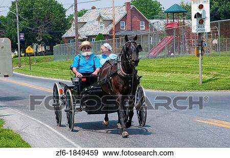 Amish couple in old fashioned horse carriage on street in Intercourse Pennsylvania in Lancaster area of Amish country View Large Photo Image Stock Photo - Amish couple in old fashioned horse carriage on street in Intercourse Pennsylvania in Lancaster area of Amish country. Fotosearch
