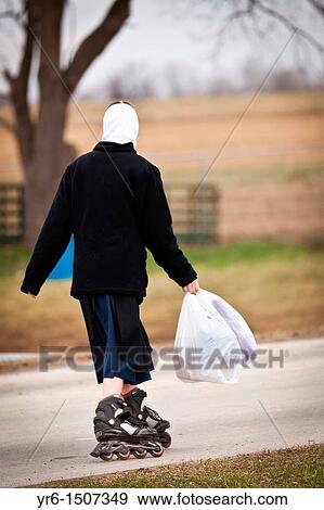 Amish girl roller blades home from school in Gordonville, PA View Large Photo Image Stock Photo - Amish girl roller blades home from school in Gordonville, PA. Fotosearch