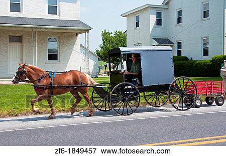 Amish man in old fashioned covered horse carriage on street in Intercourse Pennsylvania in Lancaster area of Amish country View Large Photo Image Stock Photo - Amish man in old fashioned covered horse carriage on street in Intercourse Pennsylvania in Lancaster area of Amish country. Fotosearch