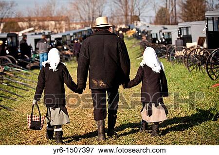 Amish man walks with his children past dozens of buggies ready for auction during the Annual Mud Sale to support the Fire Department in Gordonville, PA View Large Photo Image Stock Photo - Amish man walks with his children past dozens of buggies ready for auction during the Annual Mud Sale to support the Fire Department in Gordonville, PA. Fotosearch
