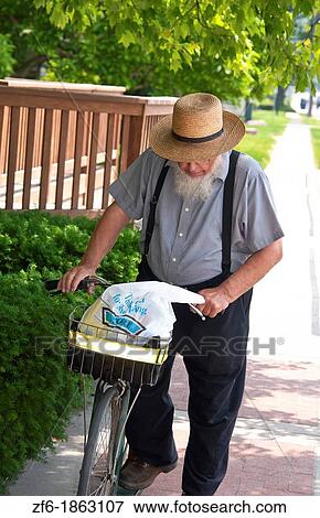 Amish man with bike in Intercourse Pennsylvania in Lancaster area of Amish country View Large Photo Image Stock Photo - Amish man with bike in Intercourse Pennsylvania in Lancaster area of Amish country. Fotosearch