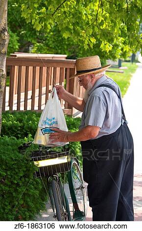 Amish man with bike in Intercourse Pennsylvania in Lancaster area of Amish country View Large Photo Image Stock Photograph - Amish man with bike in Intercourse Pennsylvania in Lancaster area of Amish country. Fotosearch