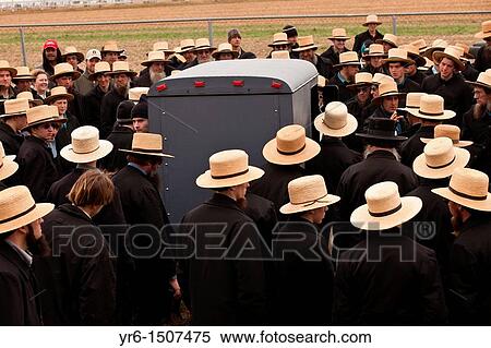 Stock Photography - Amish men bid on horse buggies during the Annual Mud Sale to support the Fire Department in Gordonville, PA. Fotosearch
