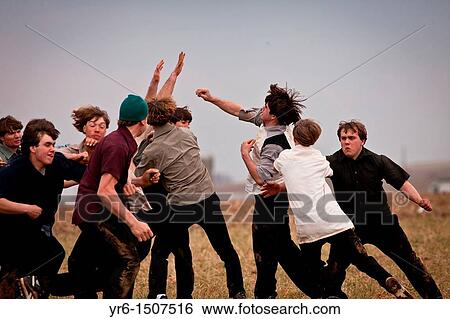 Amish play football in a farm field during the Annual Mud Sale to support the Fire Department in Gordonville, PA View Large Photo Image Stock Photograph - Amish play football in a farm field during the Annual Mud Sale to support the Fire Department in Gordonville, PA. Fotosearch